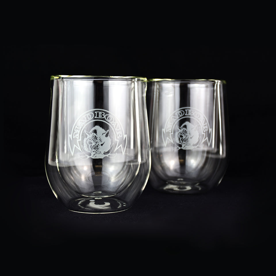 two clear wine tumblers with mad boar logo